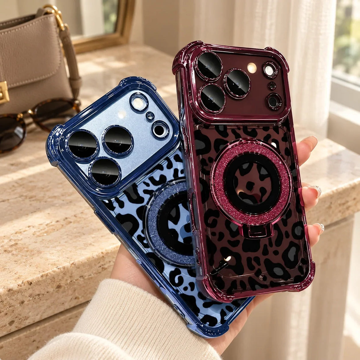 Burgundy and blue leopard phone cases together beside a neutral handbag